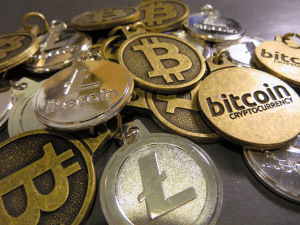 A bunch of of coins with the Bitcoin logo on them