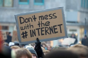 Someone holding a sign to don't mess with the internet
